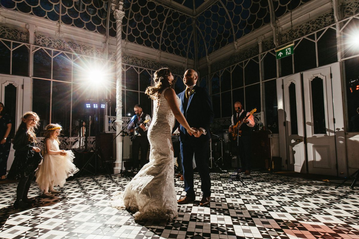 A bride and groom dance in the Conservatory