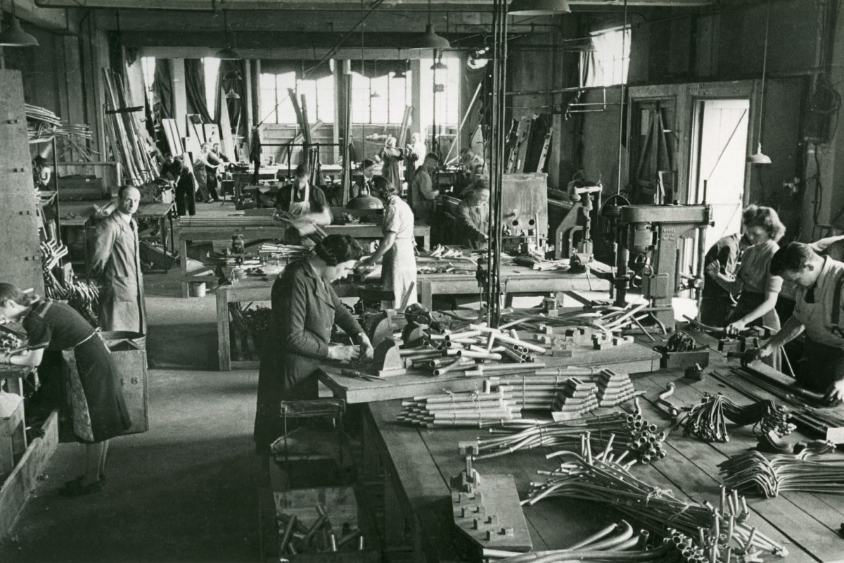 black and white image of people making pipes.