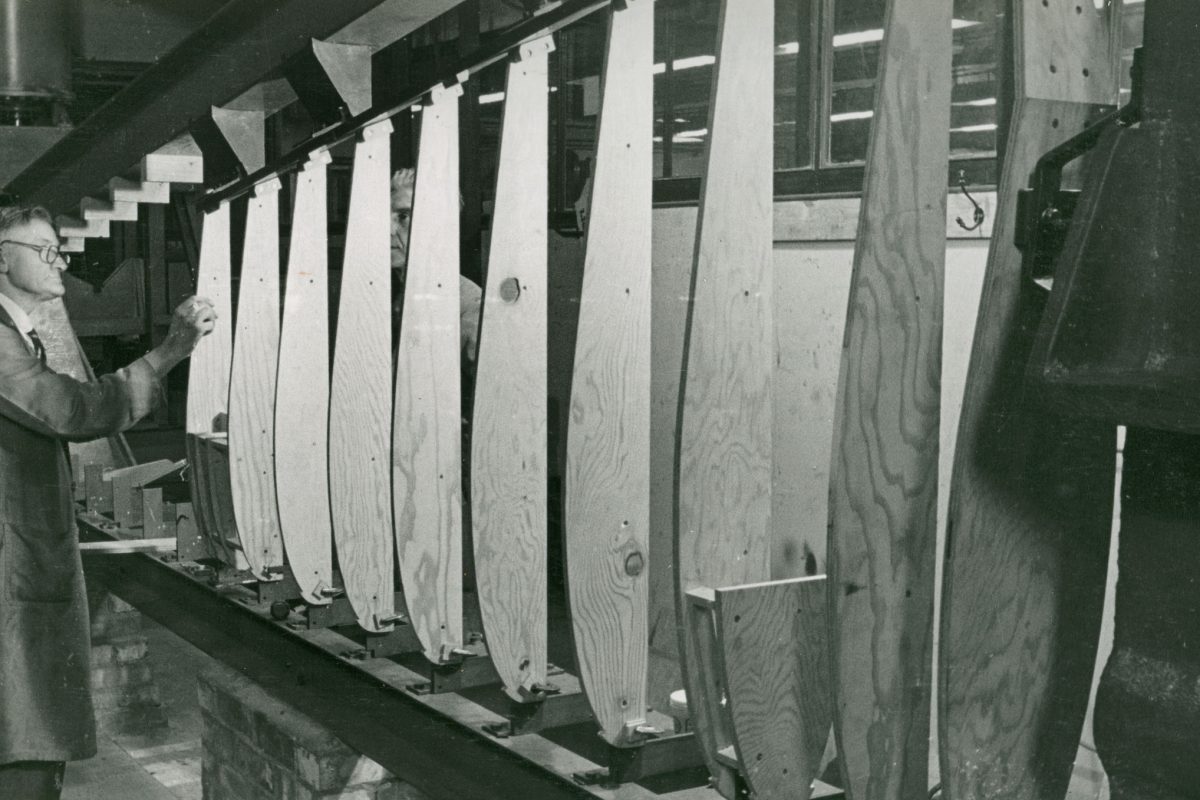 Man standing by wooden panels