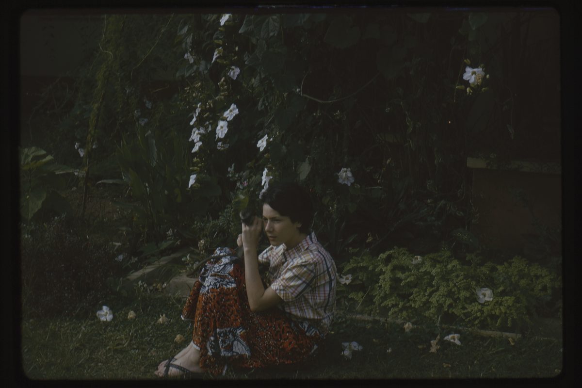 Woman being photographed holding a monkey