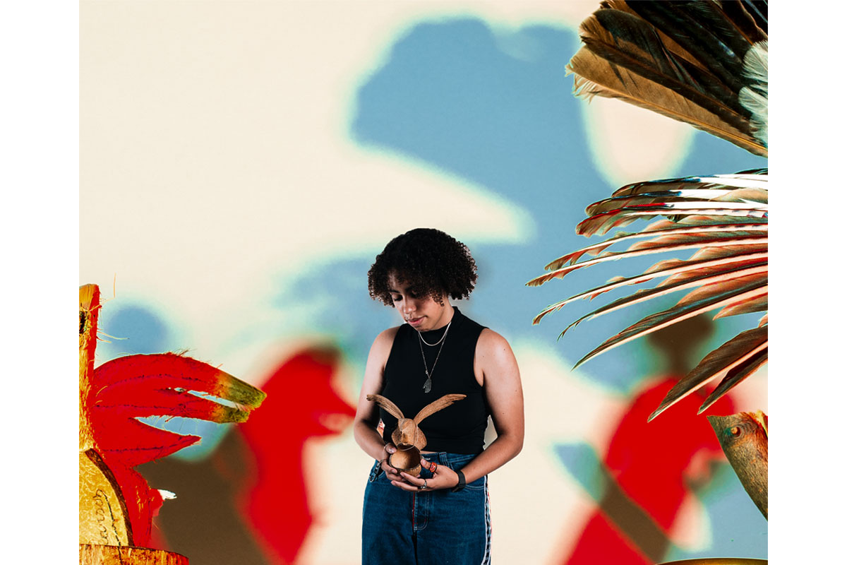 Woman wearing a black top holds a model of a bird